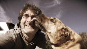 Dog Licking Man's Face